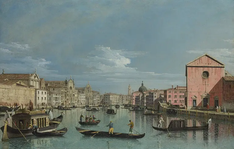 A tranquil view of a Venetian canal bustling with gondolas and boats. Historic buildings line the waterway under a clear sky, showcasing architecture in soft colors, with reflections shimmering in the water. The scene captures the charm of daily life in Venice.