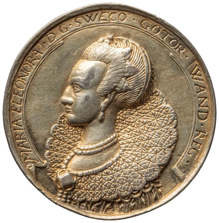 A bronze medallion featuring a profile portrait of a woman with elaborate hair and a textured collar. The inscription around the edge includes the name