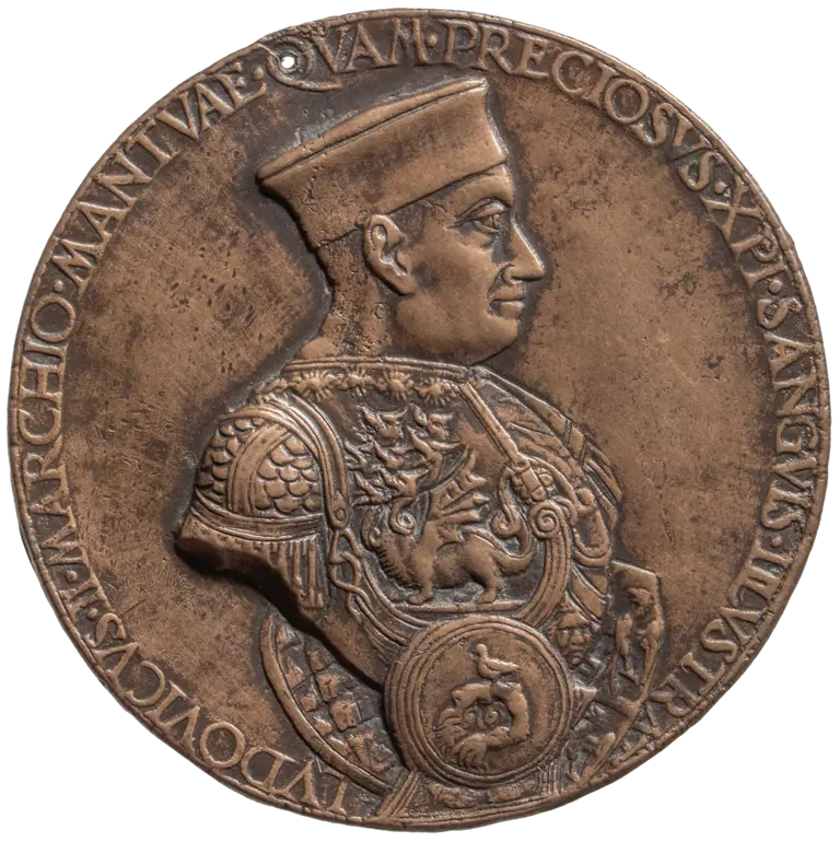 A circular bronze medal features a profile of a man adorned in intricate armor and a cap. Surrounding the figure are Latin inscriptions, emphasizing his significance. The medal's surface is textured, highlighting the details of his armor and facial features.