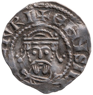 Alterstext: Eine silberne Münze, die ein menschliches Gesicht mit einer Krone zeigt. Der Gesichtsausdruck ist neutral, und die Münze hat umrandende Schriftzeichen. Die Rückseite ist nicht sichtbar.