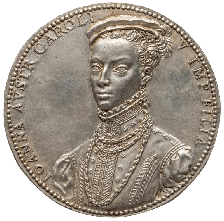 A silver medal featuring a formal portrait of a woman with an intricate hairstyle, wearing a high-collared, embellished dress adorned with pearls. The inscription around the edge reads 
