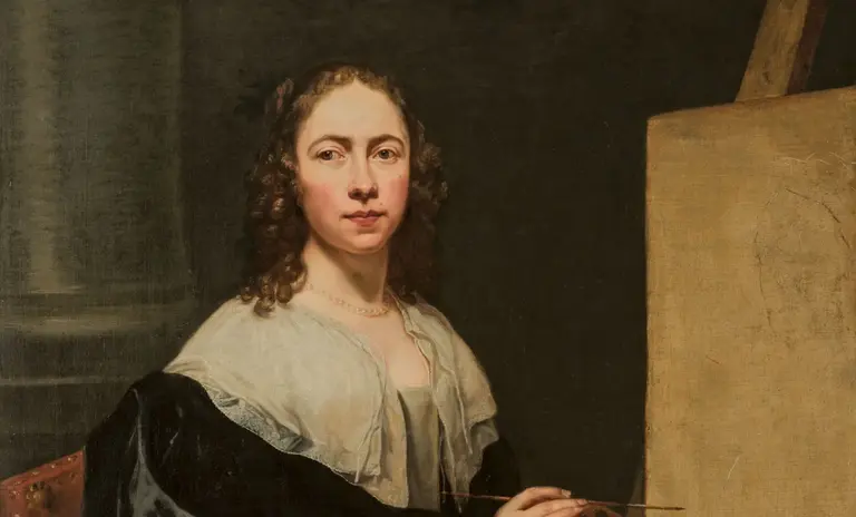 A woman with curly hair sits in front of an easel, holding a palette and brushes. She wears a dark, elegant dress with a light shawl. The background is dark, drawing attention to her focused expression as she prepares to paint.