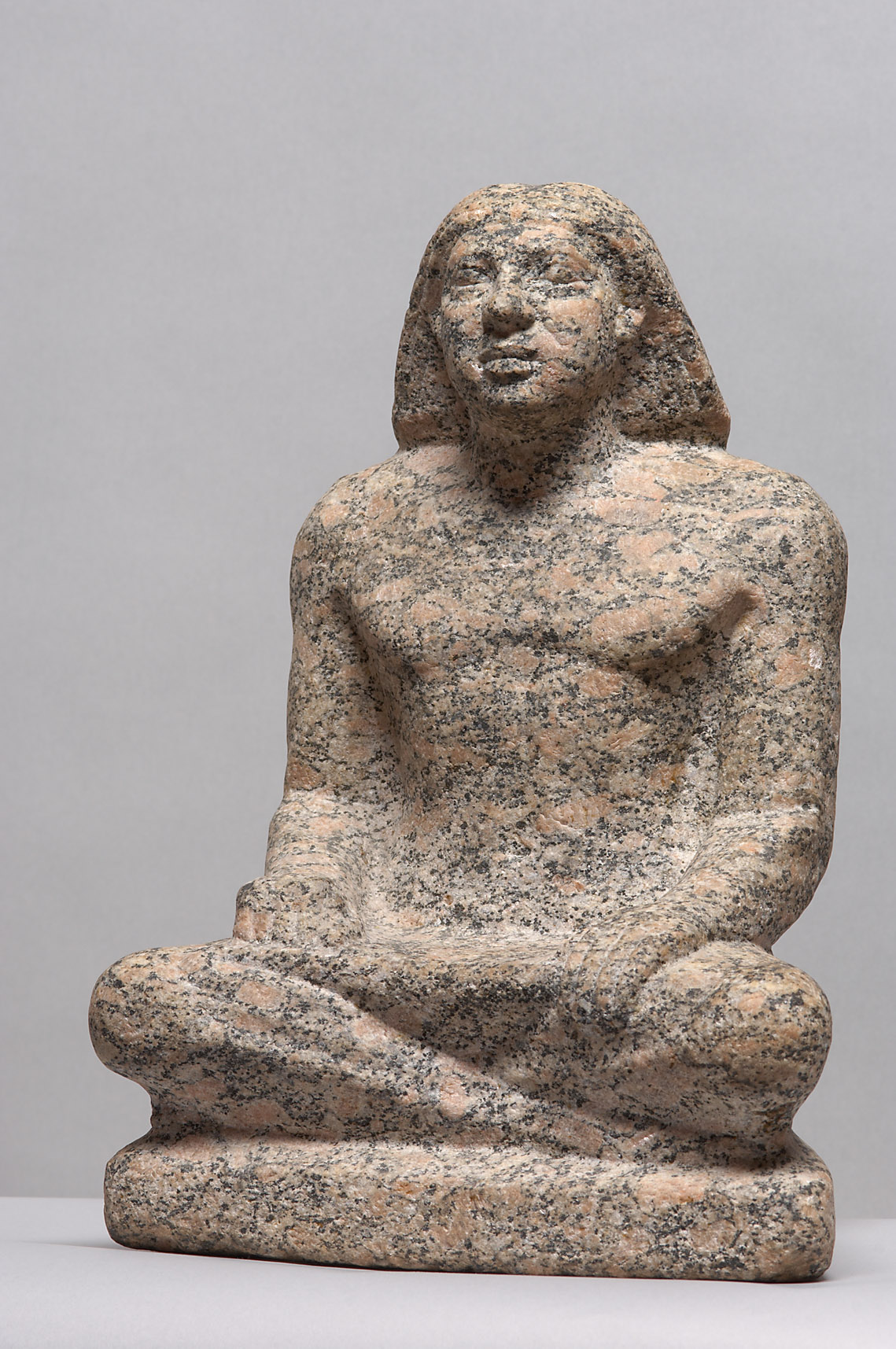 Statue of a man sitting cross-legged