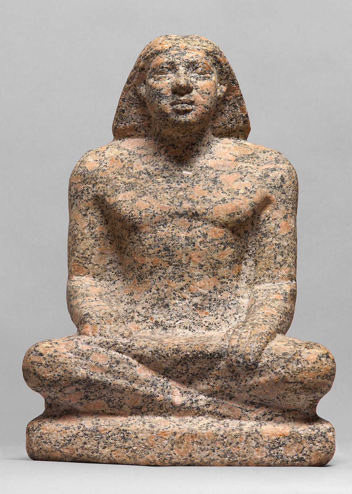 Statue of a man sitting cross-legged