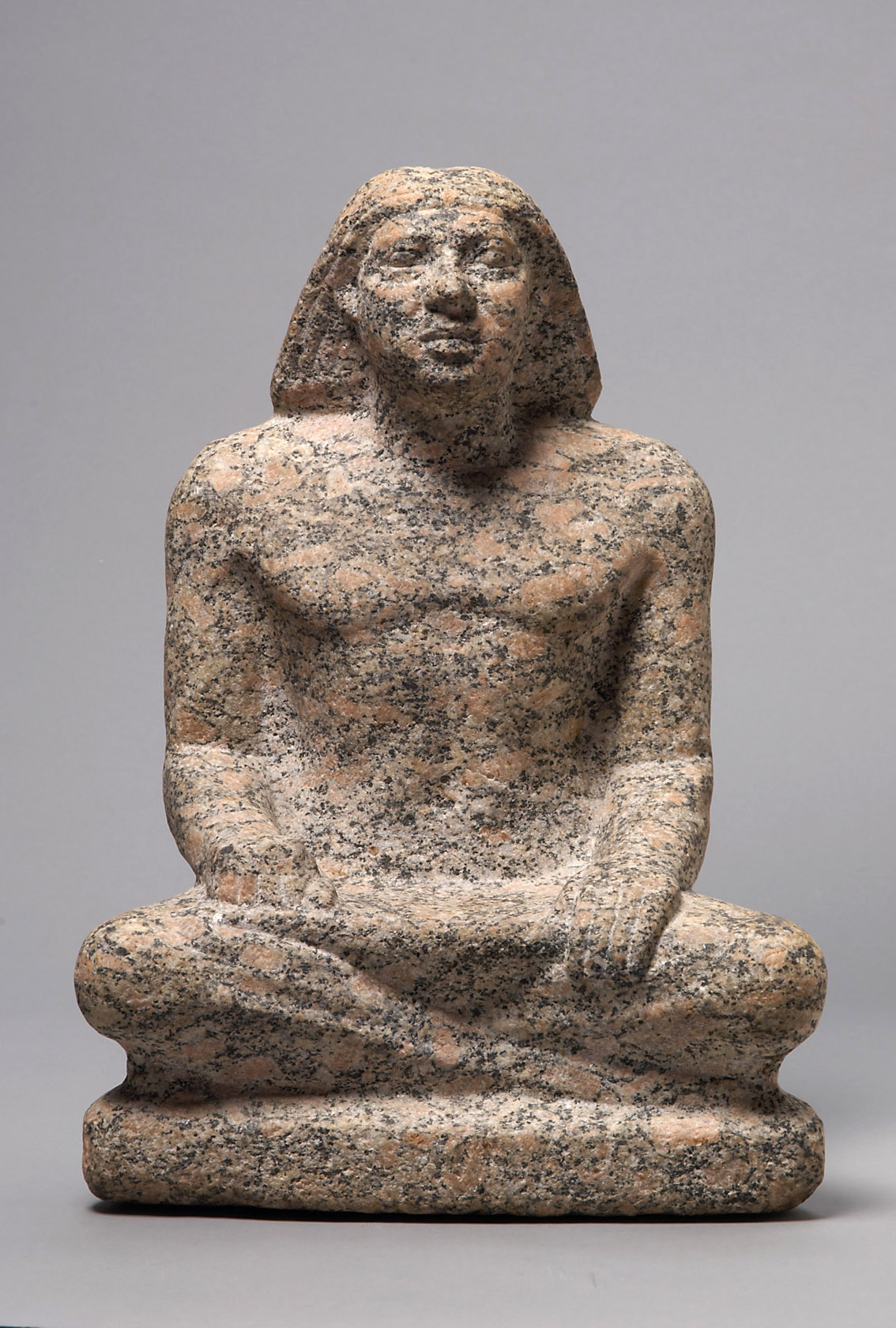 Statue of a man sitting cross-legged