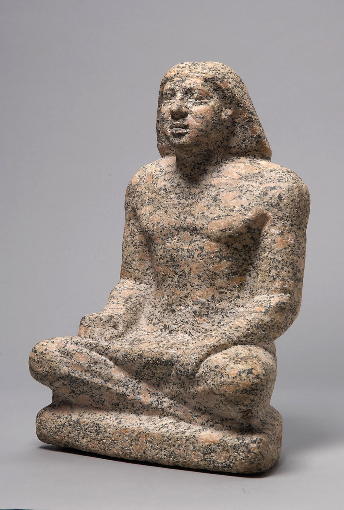 Statue of a man sitting cross-legged