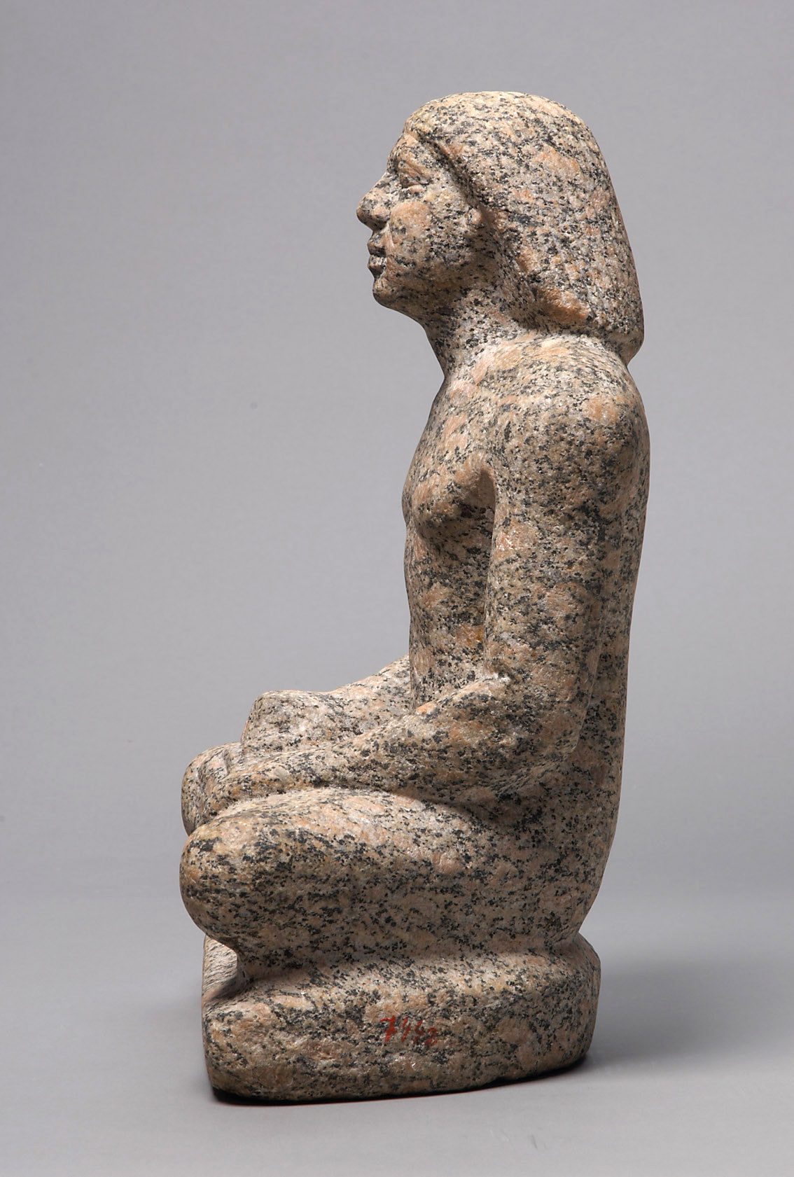 Statue of a man sitting cross-legged