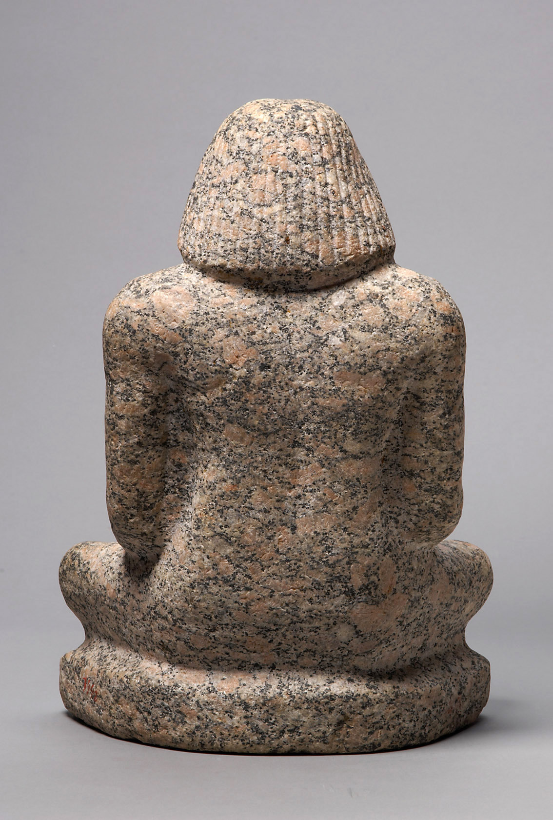 Statue of a man sitting cross-legged