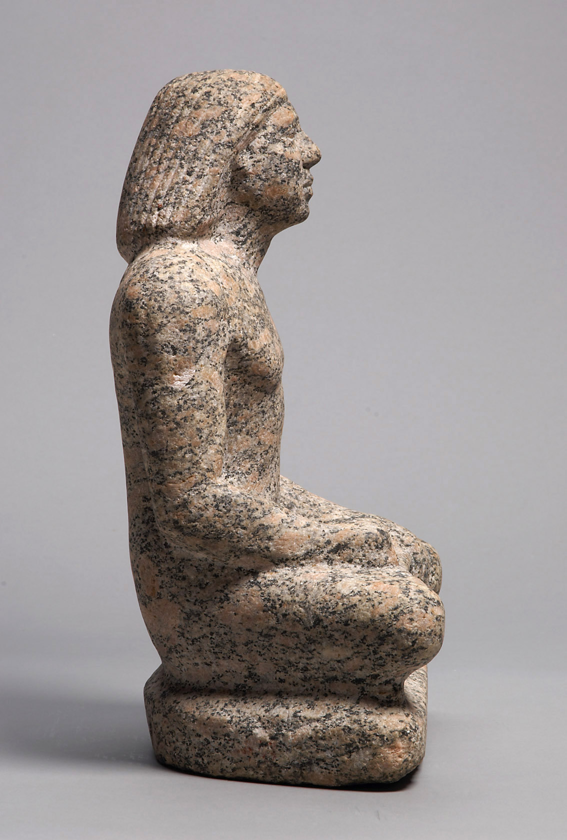 Statue of a man sitting cross-legged