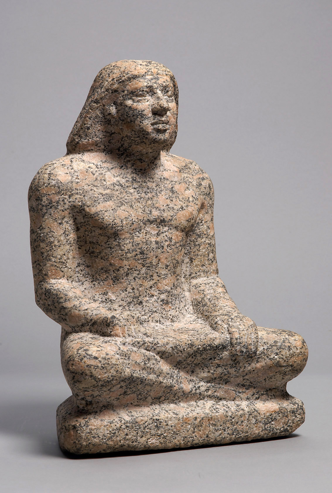 Statue of a man sitting cross-legged