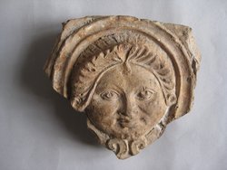 Fragment einer Verkleidungsplatte mit Masken in schlangenförmig gewundenen Bändern: Gorgoneion