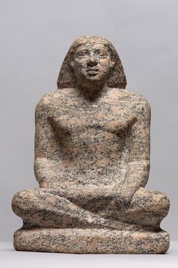 Statue of a man sitting cross-legged