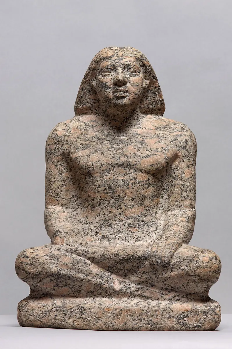Statue of a man sitting cross-legged