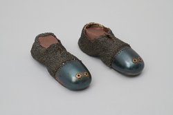 A pair of mail-reinforced leather shoes