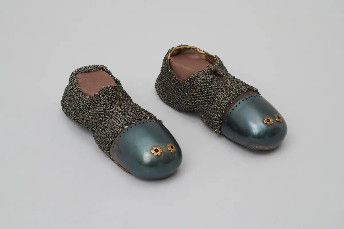 A pair of mail-reinforced leather shoes
